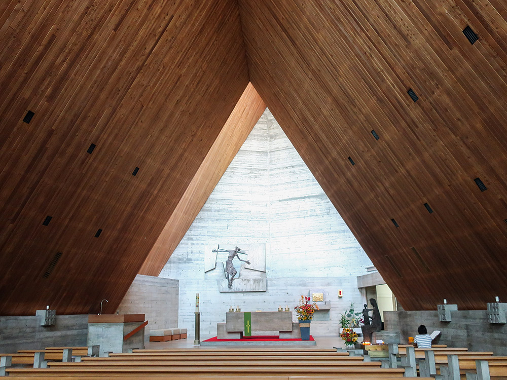 The interior of the church has a clean simple feel thanks to the use of few materials such as concrete and larch wood. The chancel is set back and has a high roof allowing light to fall directly into the altar space. (image used with permission)